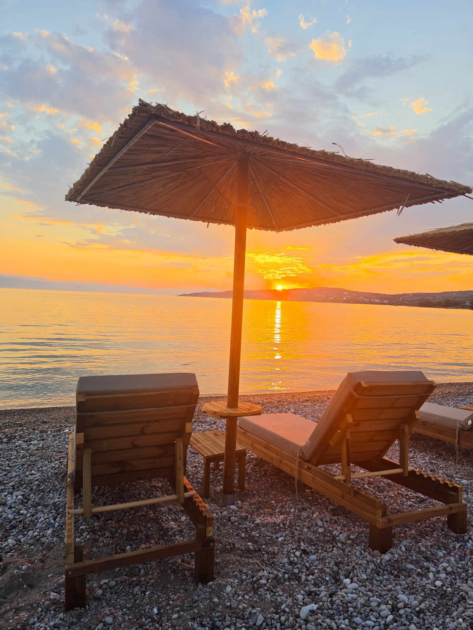Beach loungers at sunset